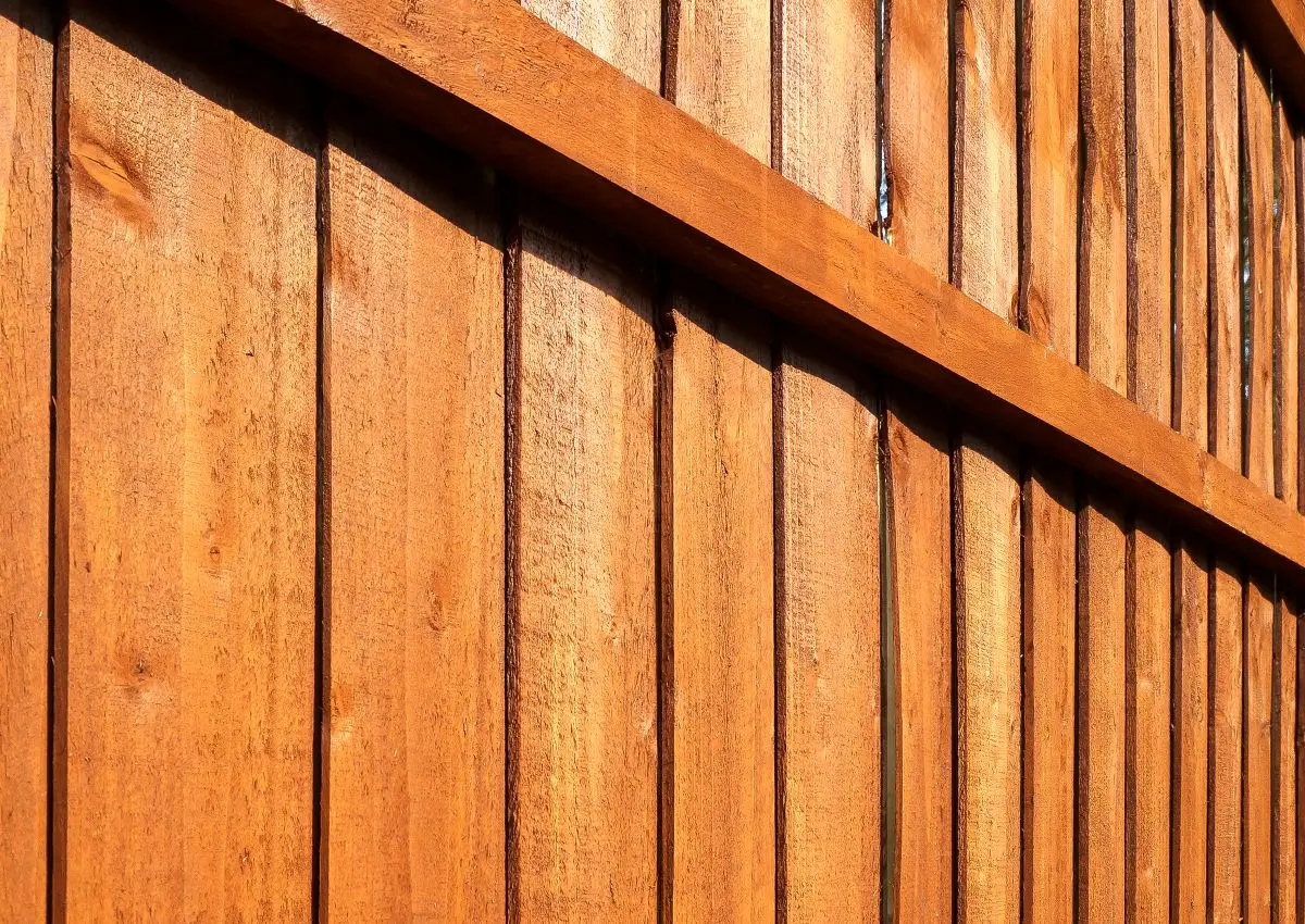 Close-up of wooden garden fence close up with vertical panels and horizontal