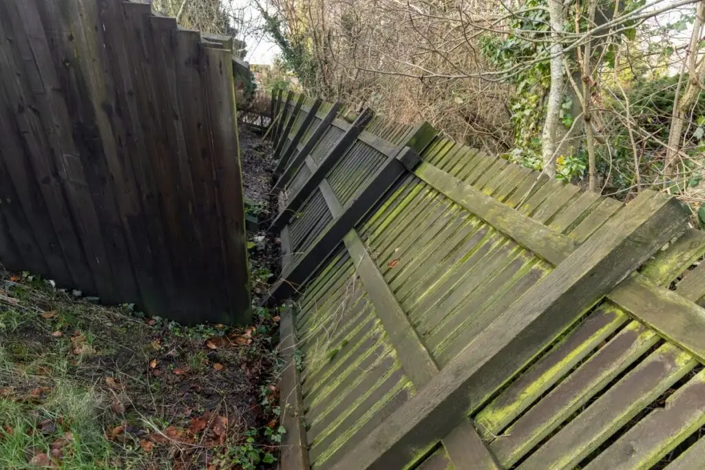 An old, leaning fence that needs repair