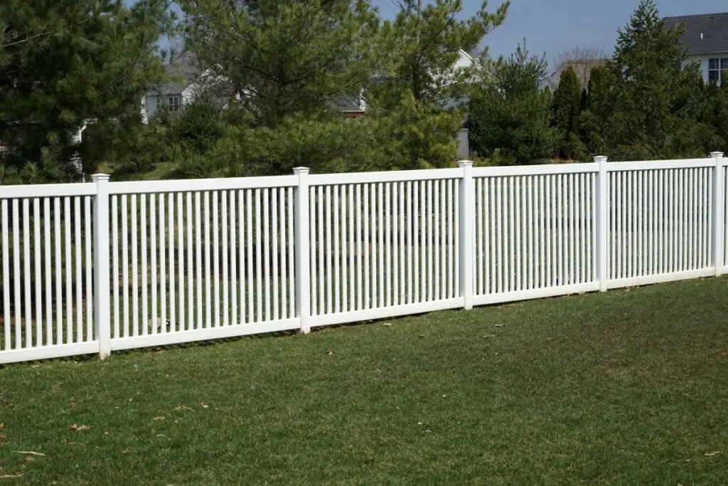 Newly installed white vinyl fence