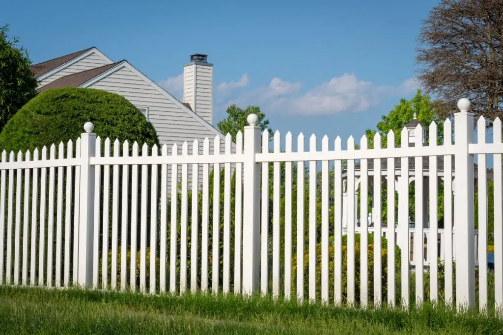 White vinyl fence in a village