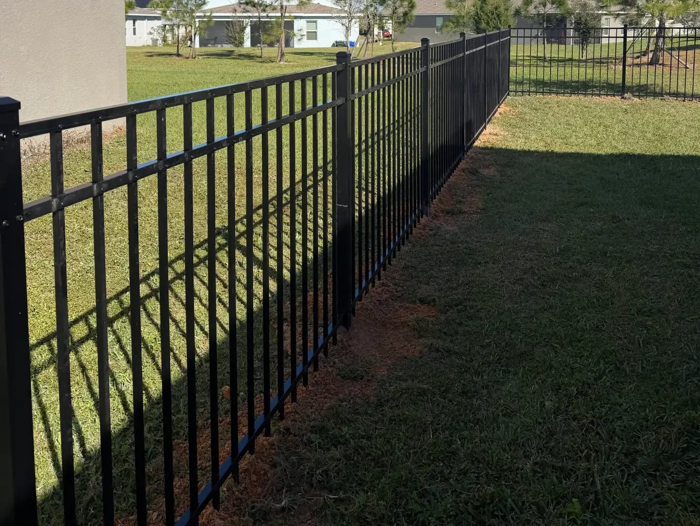 black aluminum fence on field