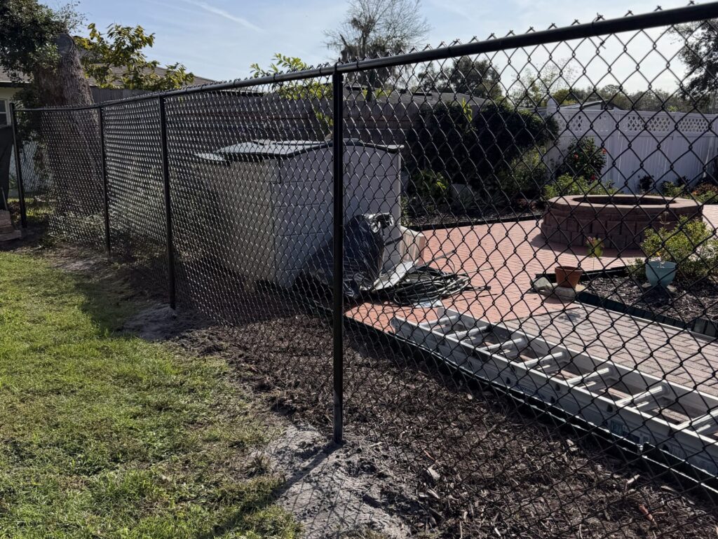 black aluminum fence green grass removed land