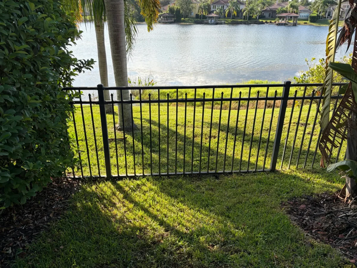 hoa approved fence black metallic fence lake behind