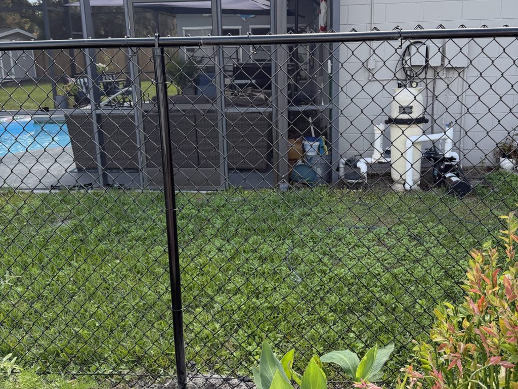 chain link fence installation long window and water system installation behind