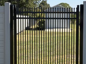aluminum fence green field behind