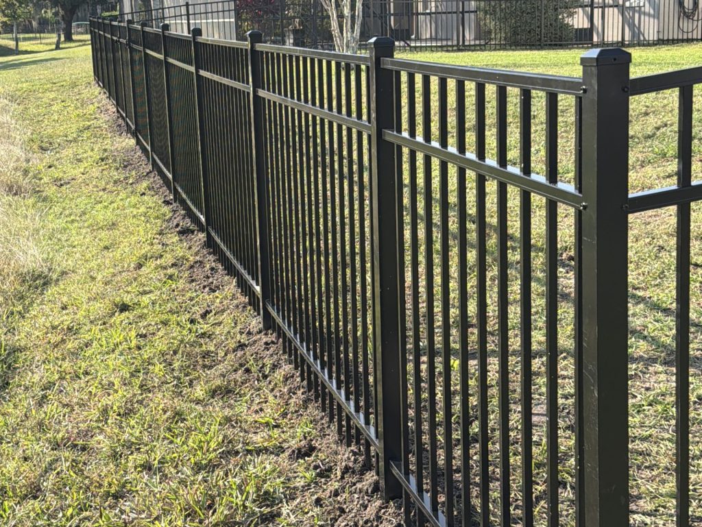 aluminum fence panels big green fied behind