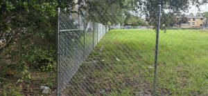 chain link fence installation big field behind grey fence
