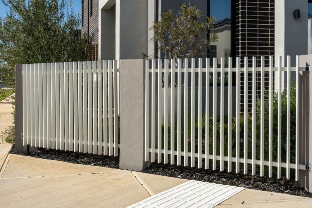 A modern white aluminium picket fence