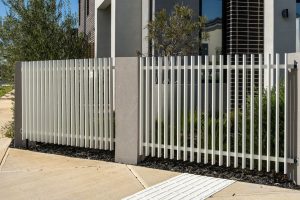 A modern white aluminium picket fence