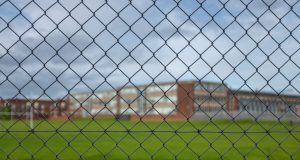 High School Building Behind A Fence
