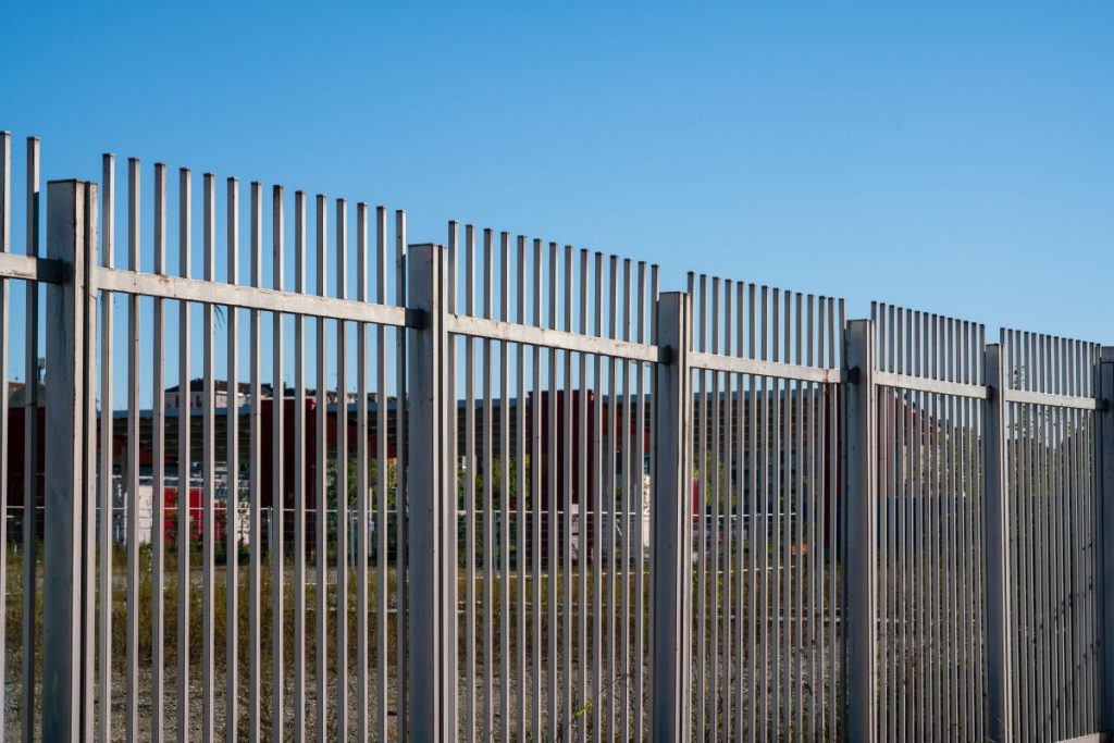 fence with steel metal grate. Detail of the grate is made with a resistant and solid structure which increases the safety of the premises
