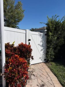 Plants in front of a fence gate