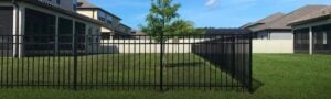 A fence being used to cordon off a backyard from a neighbor’s property